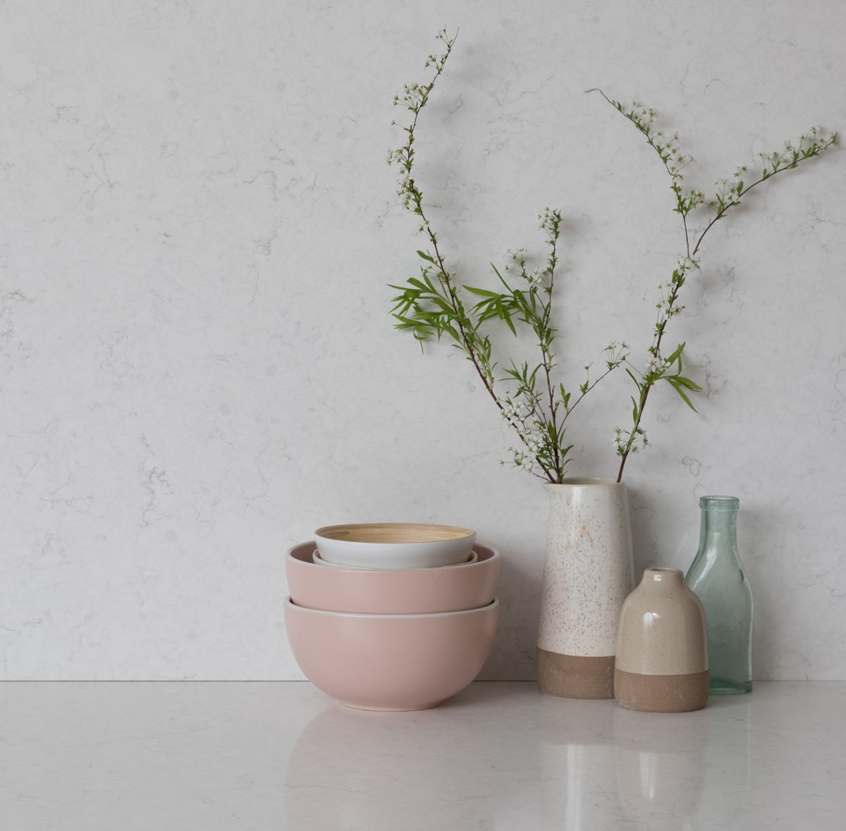 To maintain a harmonious look in your scandi kitchen, consider using the same material for your worktops and splashback. Choose a quartz worktop with patterns and colours that complement your overall kitchen theme and extend it to the splashback. Pictured: CRL Quartz White Water