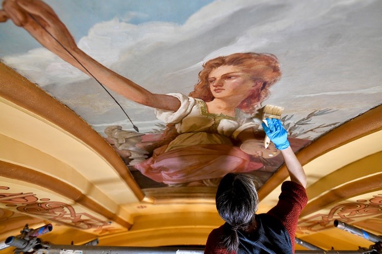After cleaning the #mistatecapitol muses, art conservators began the repair process by consolidating loose & flaking paint to reattach it to the canvas. They then applied a coat of varnish over the entire canvas to act as a protective layer and enhance the original paint colors.