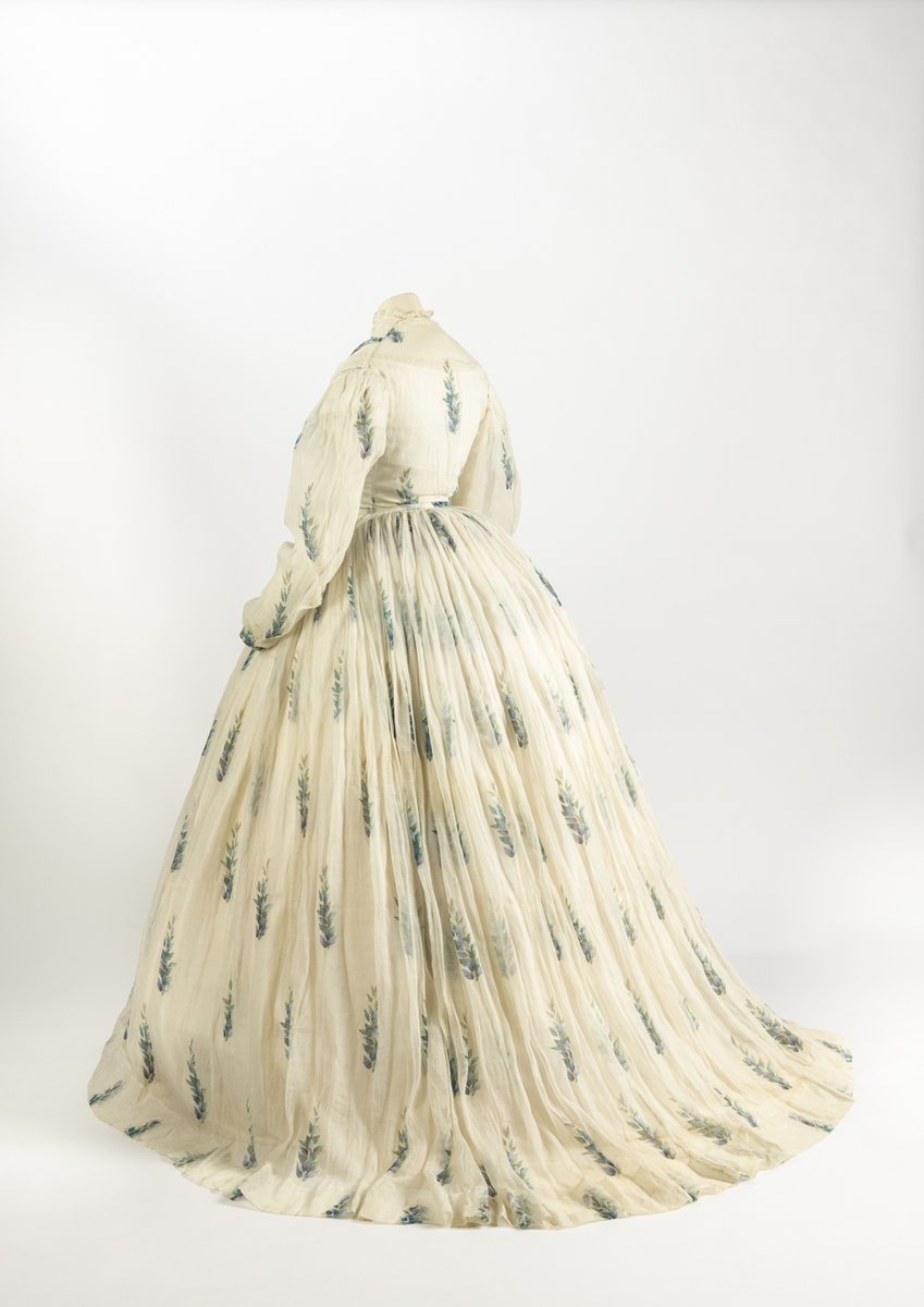 Friday Treat Time and Spring is officially on its way with this heavenly white muslin day dress from the mid-1860s. Made up of a separate bodice and skirt, this fabulous example of fashionable daywear features a blue and green printed leaf design and a delicate lace trim.