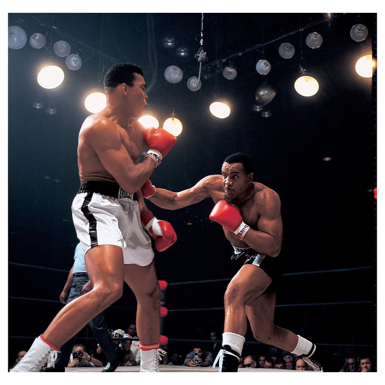 Sonny Liston throws a right hook at Muhammad Ali during the first round of the World Heavyweight Title bout at St. Dominic's Arena. Lewiston, Maine. Maine 25, 1965.