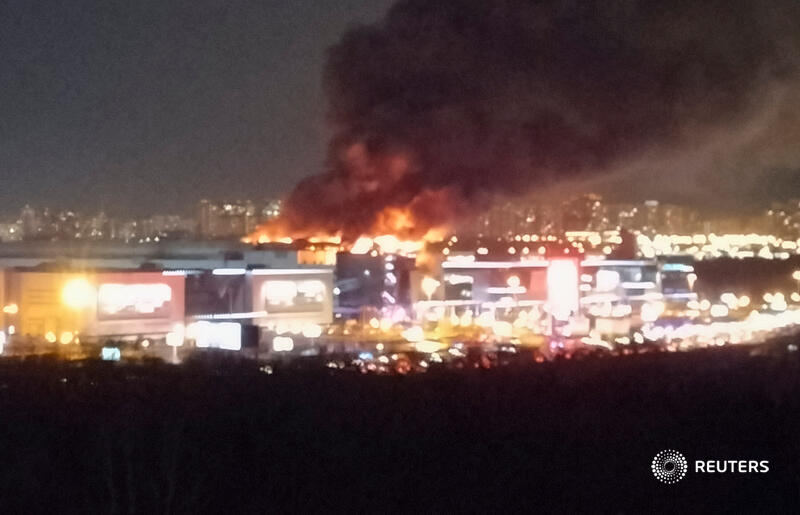 Reuters's tweet photo. BREAKING: As many as five gunmen dressed in camouflage clothing opened fire with automatic weapons at people in the Crocus City Hall music venue near Moscow, leaving an unknown number of people dead and injured, video footage from the scene showed https://t.co/uvEPsW4lBq https://t.co/eXlsn9yEPK