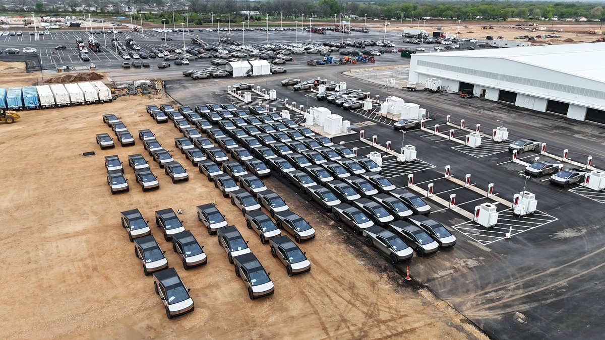 JoeTegtmeyer's tweet photo. Hundreds and hundreds a of Cybertrucks at Giga Texas today! W outbound lot, E side of new EOL & W Supercharger station filled to overflowing, & about 100+ more in the E testing lot! More coming out of the SE side of the factory too, non-stop during my drone flight time today! Hope customers get these soon!