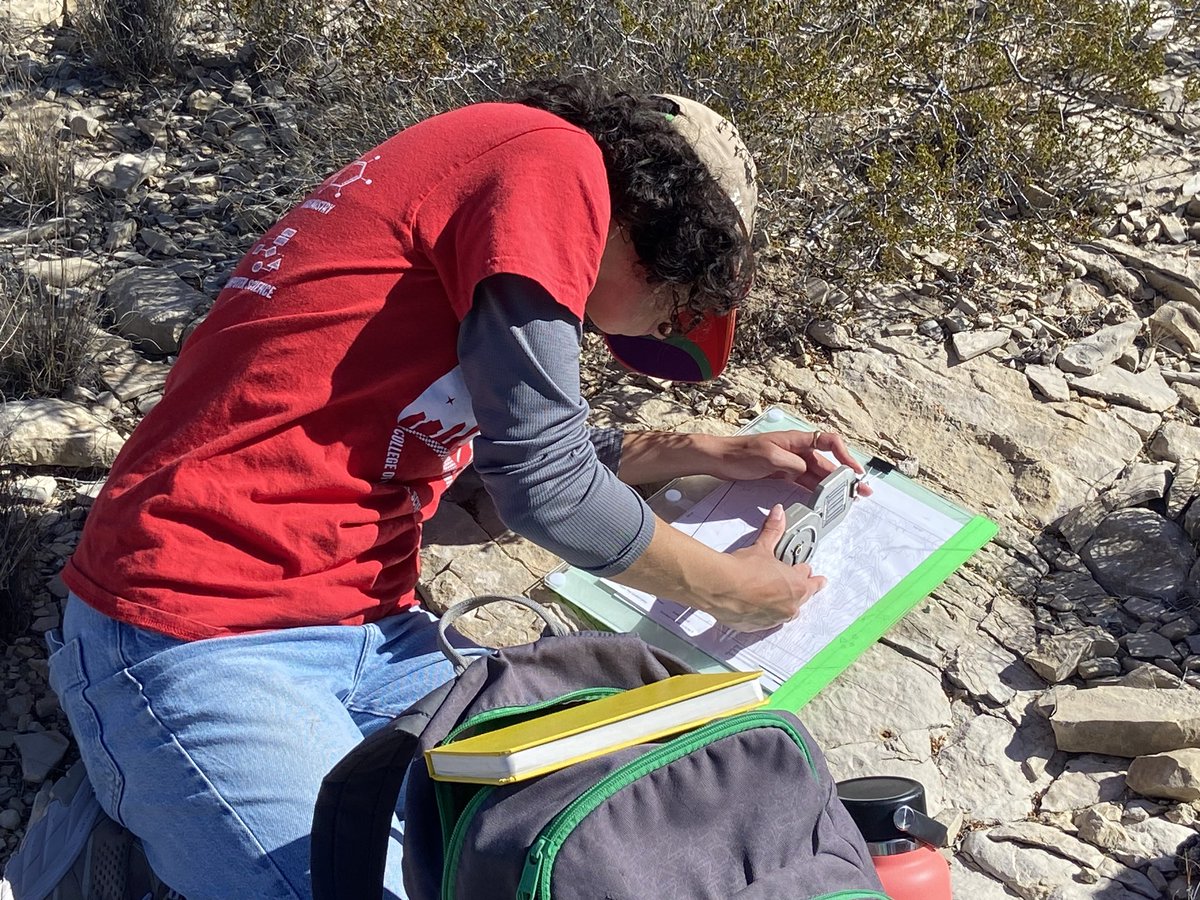 UH Geologic Field Methods in Big Bend National Park. Day 5/7, the last full day of field mapping. Photo: Measuring the spatial orientation of tilted rocks using a Brunton compass.