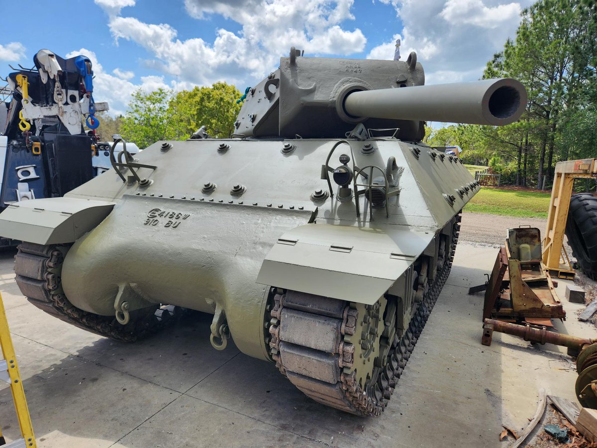 ww2armor's tweet photo. Now hear this!

Work continues here at WW2 Armor on our February 1943 built M10 Gun Motor Carriage (GMC) used by the U.S. Tank Destroyer Forces during World War II.

Over the last year we re-configured it back to its original World War II configuration as it was heavily modified by the Israelis in the late 1950s as part of their M50 Program. As part of the program, the Israelis made numerous modifications and changes to the layout of the hull, gun, and turret which required extensive work to bring it back to its original World War II build. There are some bits on the hull from the Israeli experimental program we have opted to retain, but for the most part it's back to its original design.

This week, our team installed the M10’s fuel and oil tanks, and began the electrical wiring for the vehicle electrical systems. The M10 had the fuel capacity of 165 gallons (620 liters) with an operational range of approximately 200 miles (320 kilometers). Yesterday, we installed a General Motors 6046 twin diesel engine after an extensive overhaul and services by our maintenance department. (the engine this particular piece came with) The 6046 twin diesel was capable of producing 375 horsepower at 2,100 rpms, and enabled the M10 to have a max speed of between 25 to 30 miles per hour (40 to 48 kilometers per hour).

Once installed, our team then carefully and safely installed the M10’s turret and Mount M5 with the 3-inch gun M7 into the hull. It was a moment our team has been waiting for as there is something truly unique about the M10’s appearance. Even though it may look complete there is still much more work to be done, and we will keep you all posted as we progress.
If you are interested in reading our research article published in July 2021 on the history of our M10 GMC we invite you to read it at this URL:

https://t.co/APrZPorStD...

From our team here at WW2 Armor, we wish you all a wonderful weekend!

That is all.