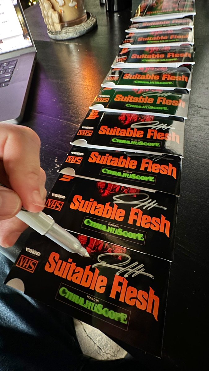 Hard at work signing those sweet, sexy lo-fi VHS boxes of SUITABLE FLESH for @brokehorrorfan & @WitterEnt, the ONLY authorized vendor for your VH-FLESH needs! Going out soon…enjoy the “Lustcraft” in all its “gore-geous” SP speed 4:3 Pan N Scan glory!