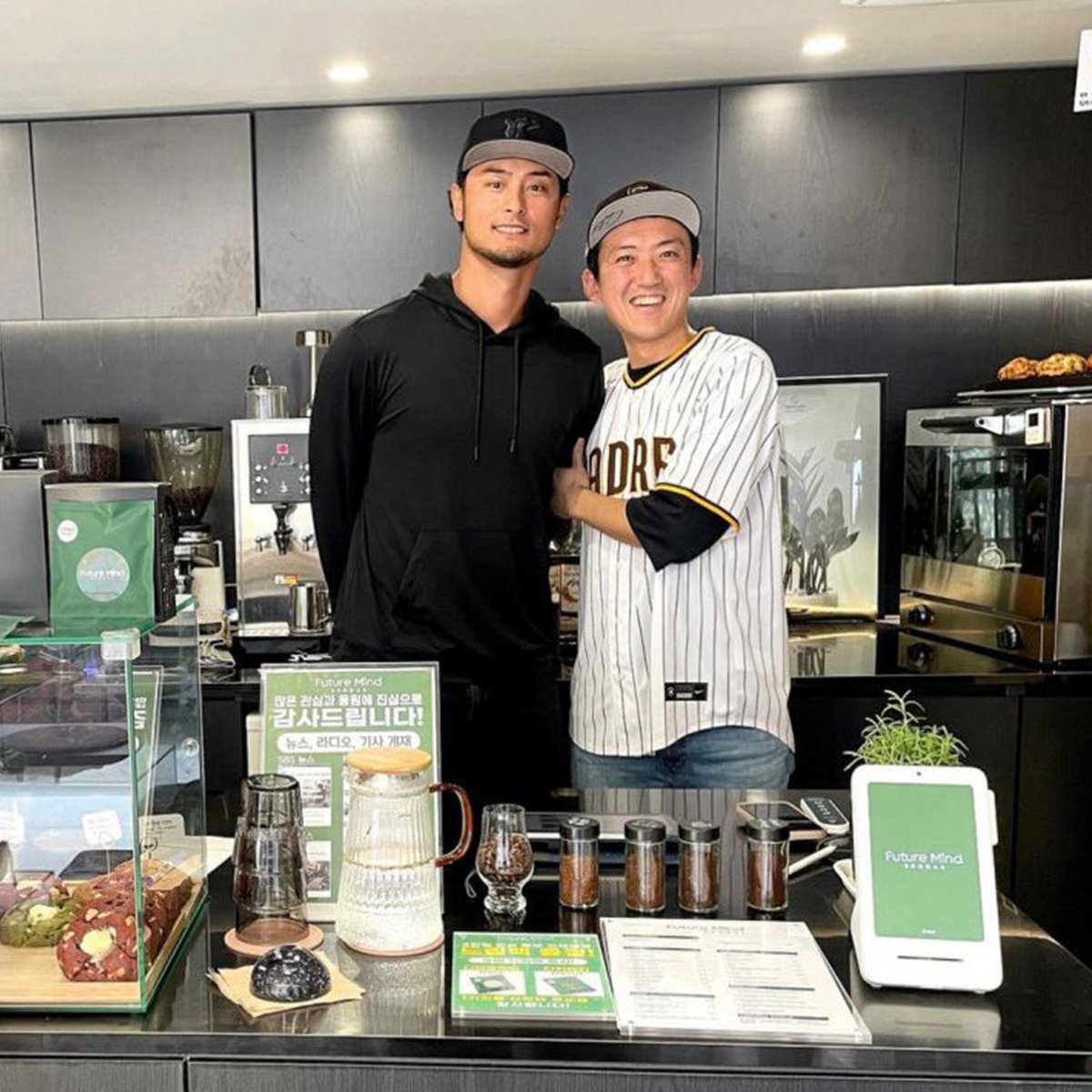 MLB's tweet photo. In 2016, Yu Darvish posted on social media about having a glove that didn't fit him. A fan, Kwang-Hee Lee, replied and said he would cherish the glove if Darvish didn't need it. So he sent it to Lee

Fast forward to #SeoulSeries roughly eight years later, and Darvish took time out to go meet Lee at the coffee shop he owns ❤️

(via @lifemeetsart_kr)