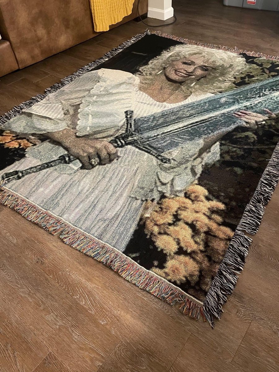 flavor_waves's tweet photo. Anyone know where I can get this rug of Dolly Parton holding the Moonlight Greatsword? Asking for a friend. I'm the friend. https://t.co/RvgUvNkoZr