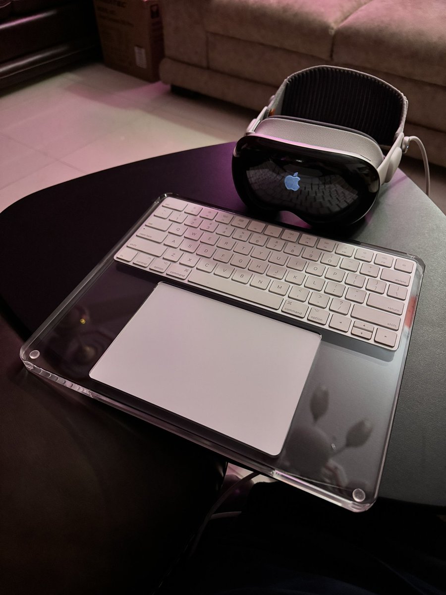 TaimurAsad's tweet image. My new desk setup ᯅ 
P.S. Loving this case for Magic Keyboard+Trackpad. Kinda complements translucent interface of visionOS. 
#VisionPro #SpatialComputer