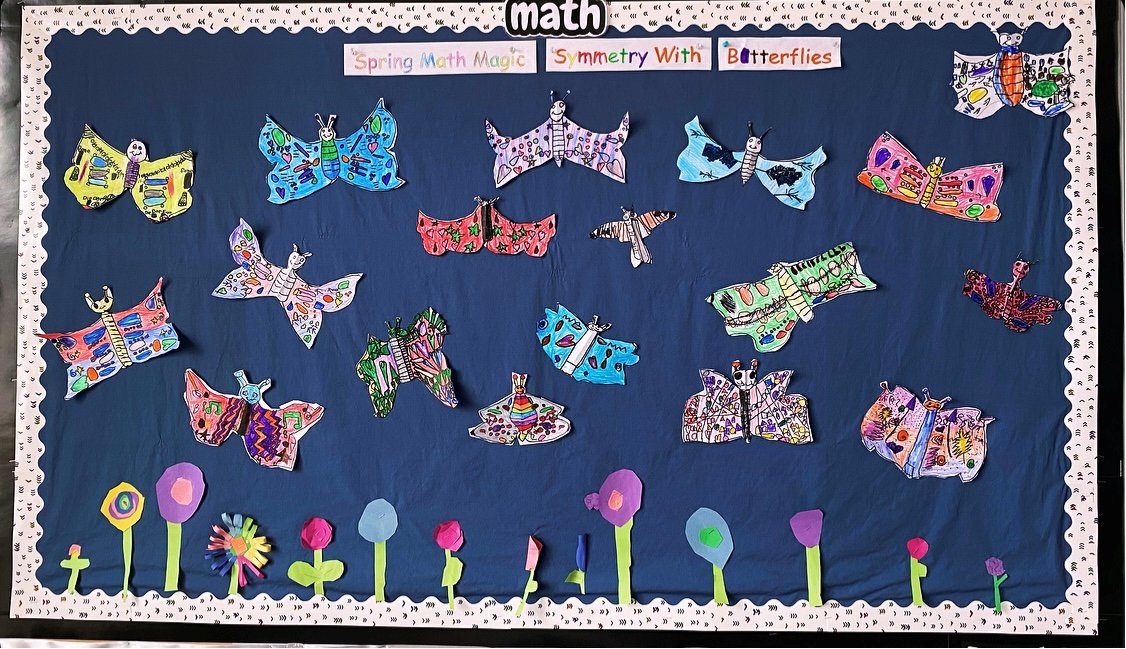 Grade 1s are learning symmetry indoors with butterflies while outside, Mother Nature's still deciding between snowflakes and spring flowers. #SymmetrySavvy #SpringSnowStruggle #Grade1math