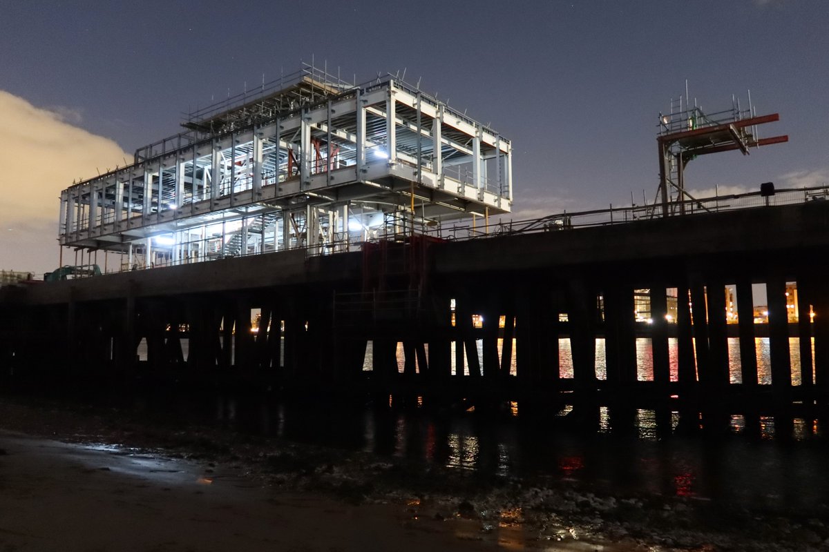 Deptford dusk, dark shapes & flickering shadows rising from the retreating tide. Underfoot, centuries-old slipways, hewn from wood & stone. Above, initial construction for the redevelopment of the historic Royal Dockyard.