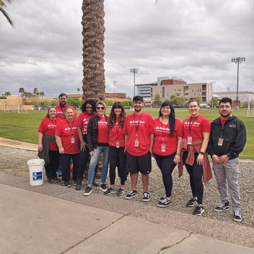 State Farm employees recently took time off work and volunteered to work fertilizer into the soil around all date palms and fruit trees.