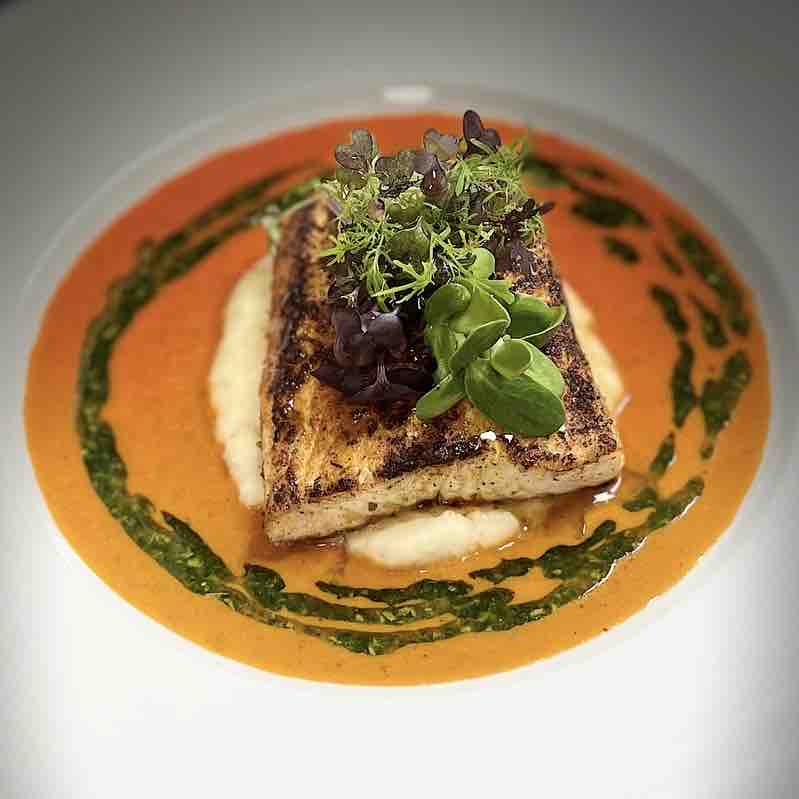 Tonight’s Special at The Sardine Factory: 

Blackened Alaskan Halibut with fire roasted tomato coulis, potato purée, wild arugula oil, local micro greens.