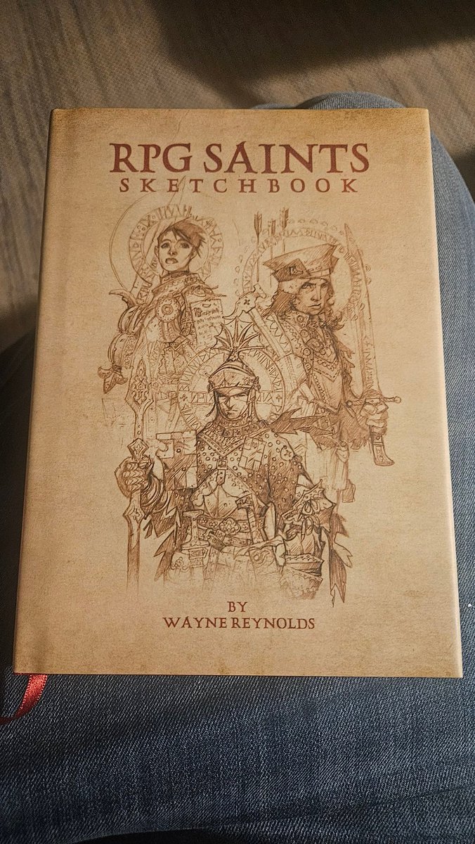 ApostolicTee's tweet photo. By chance I was rocking our "Dogma &amp; Deacons" shirt today when my copy of Wayne Reynolds' RPG Saints Sketchbook arrived! Fans of D&amp;D can get your own tee here: https://t.co/sF3E1VKatj https://t.co/N1dDUePYub