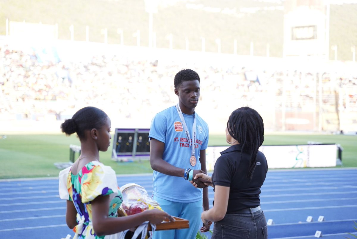 Our Marketing Manager - Ayanna Kirton hands out the medals to the 100m Hurdles Class 3 - Boys.

#GKMSOnline #ISSAChamps2024