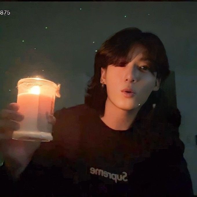 jungkook holding a candle