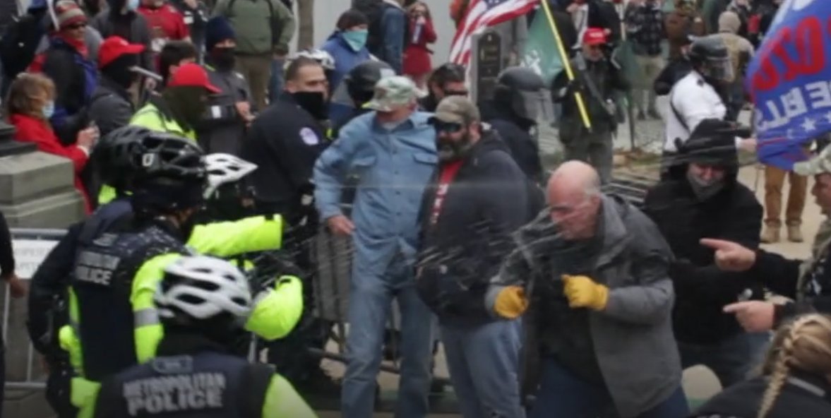 AmericanSummer4's tweet image. Mean while on the opposite side of the stairs / scaffolding at the #jan6 #fedsurrection....#yellowgloves is getting similar treatment and takes a garden hose full of pepper spray like a boss.