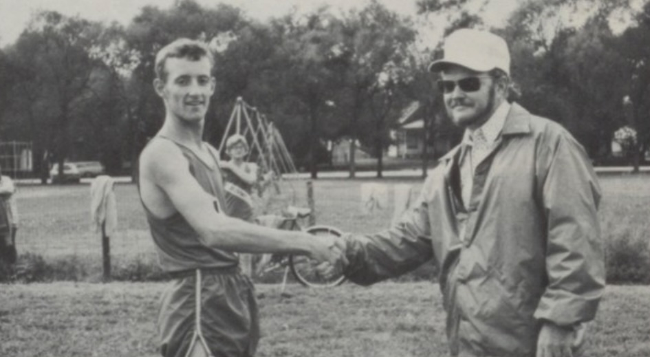 Coach Boucher and a Burwell trackster have come to some kind of 1974 agreement here. I love the swingset, bicycle, and random teammate in the background!