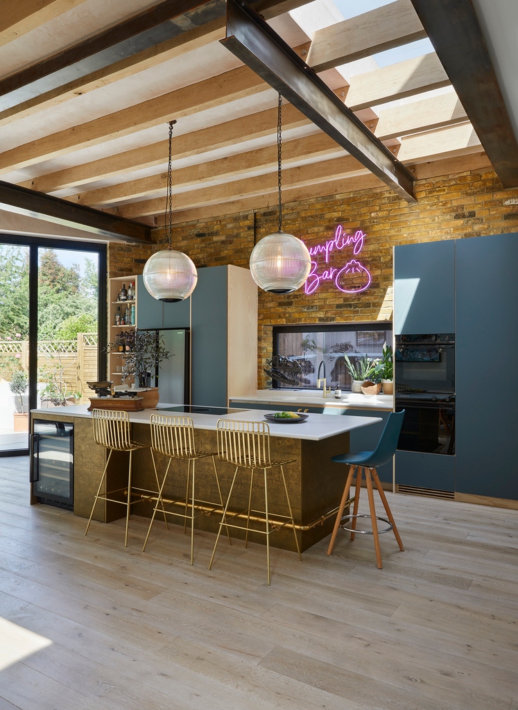 Industrial vibes meet sleek sophistication with exposed bricks and beams, solid wood cabinetry, and a stunning hammered brass kitchen island! The perfect fusion of urban edge and refined style! #industrialkitchen #modernkitchen #kitcheninspo l8r.it/T6Fw