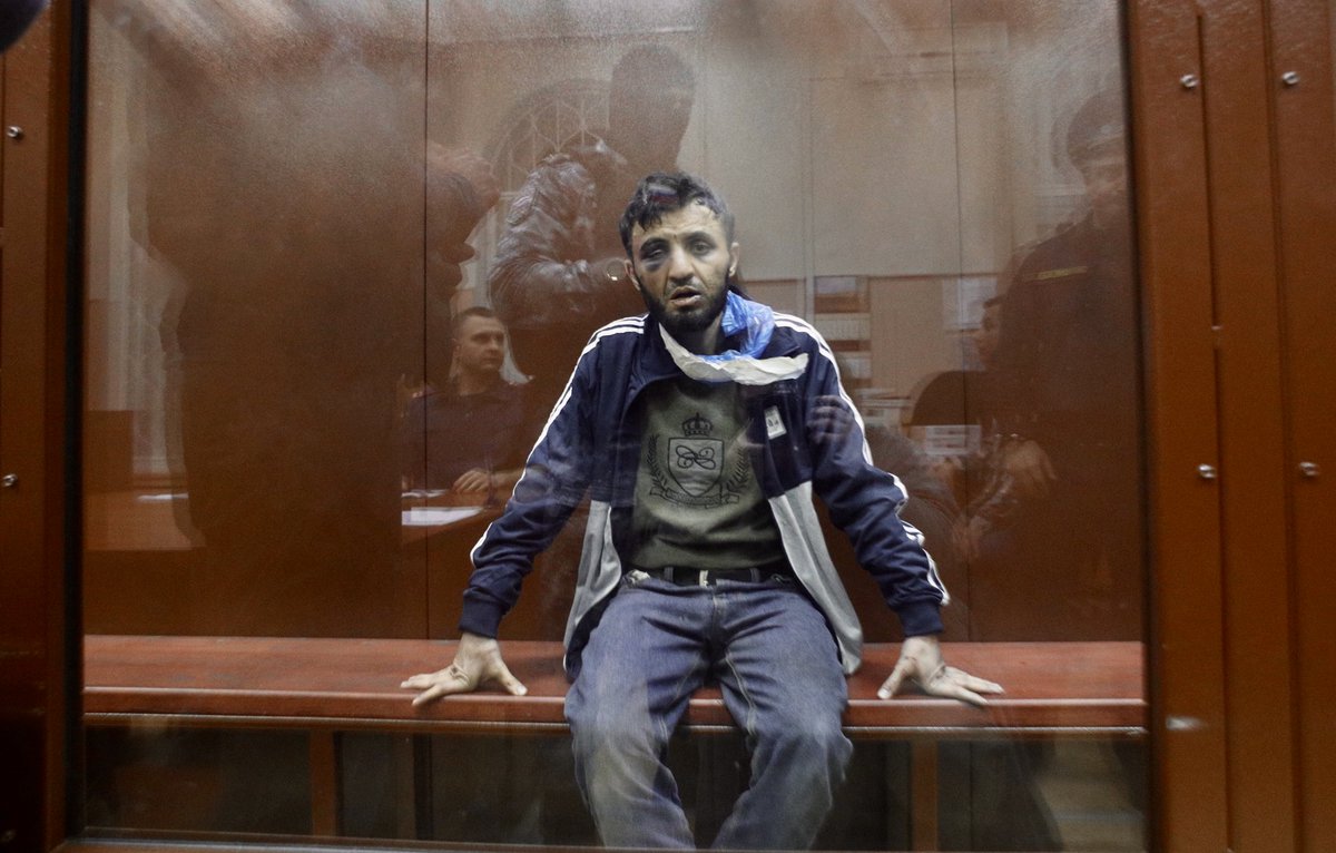 Mirzoev has a torn plastic bag around his neck and bruises on his face that were not present in the videos previously published by loyalist bloggers and propagandists

He removes the bag and sits with his head lowered as the hearing begins

Photos: Alexandra Astakhova / Mediazona