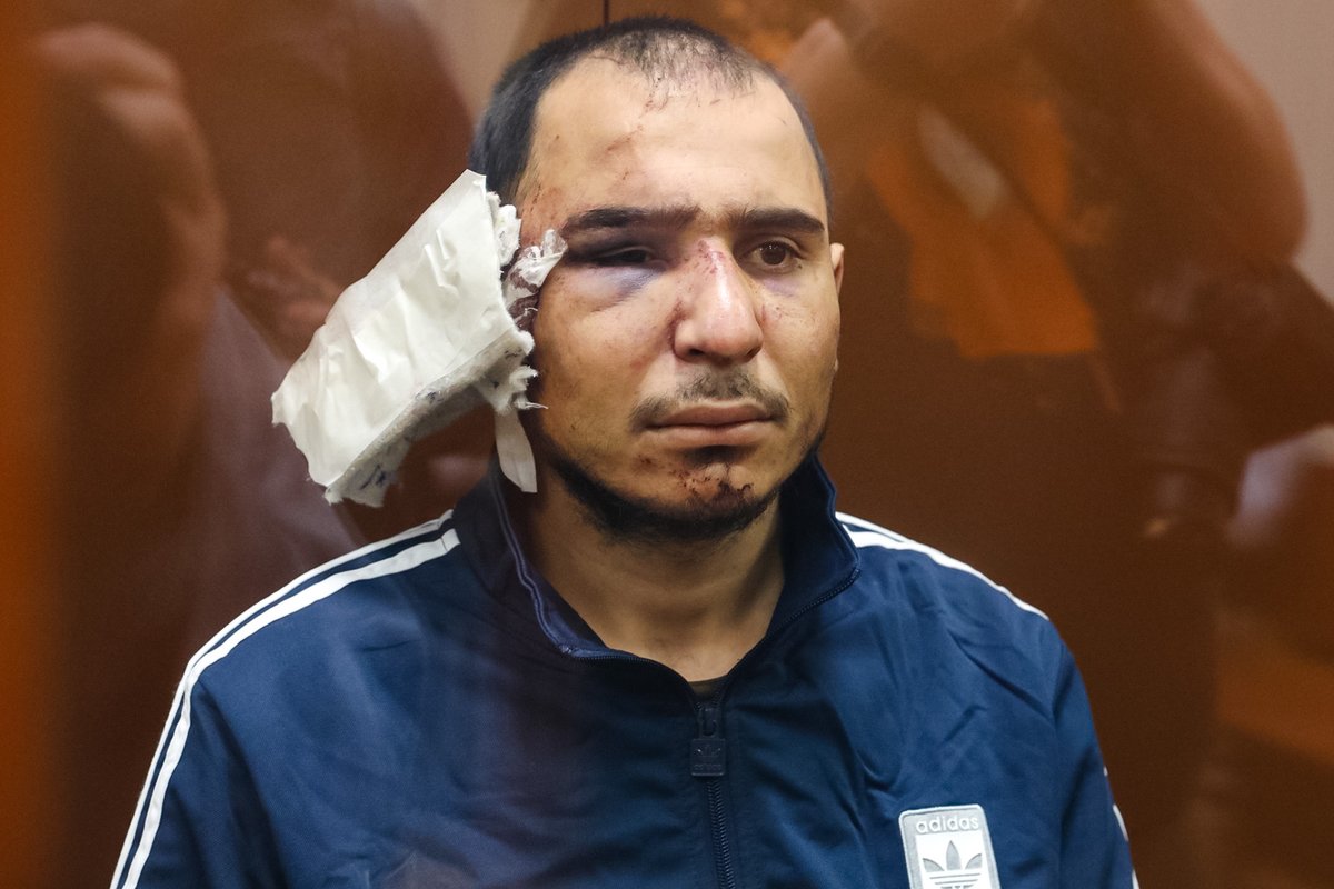 The second accused, Murodali Saidakrami Rachabolizoda, is brought into another courtroom in Basmanny Court. He is the man whom a security officer attempted to force-feed his own severed ear in a video that emerged earlier

Photo: Alexandra Astakhova / Mediazona