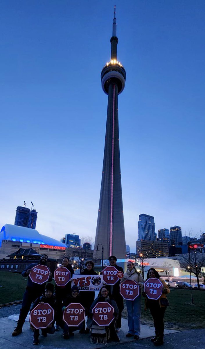 The CN Tower is illuminated in red tonight to commemorate #WorldTBDay & raise awareness for tuberculosis. TB advocates gathered to say that #YesWeCanEndTB with sustained investments & action!