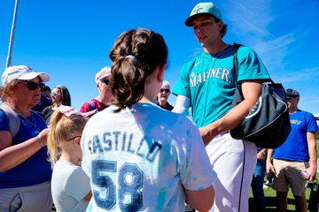 Photo of Logan Gilbert signing autographs for fans during Spring Training. 