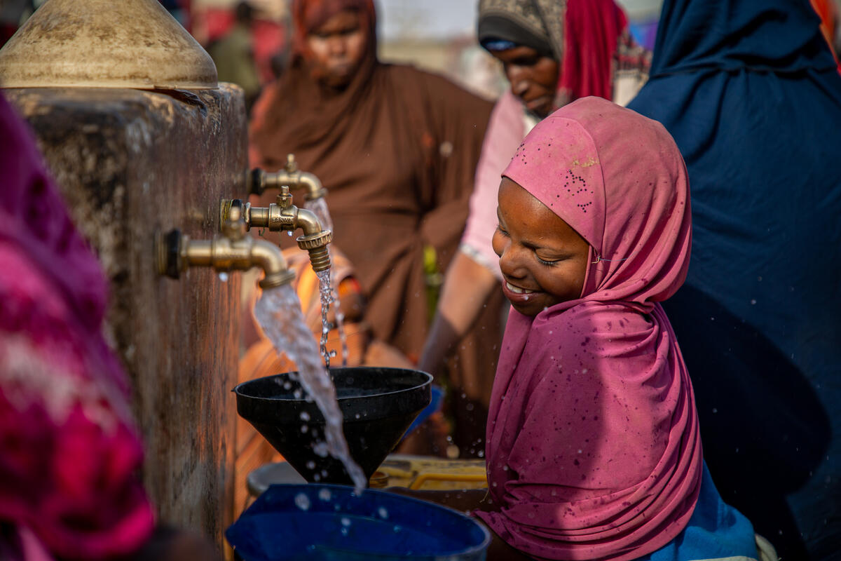 Ladan*, 10, fetches clean water for her family at a water facility in a camp for people displaced in Puntland #Somalia. Water points like this, installed by @SaveChildrenSO, are helping children keep safe from disease and stay learning in school. #WaterDay