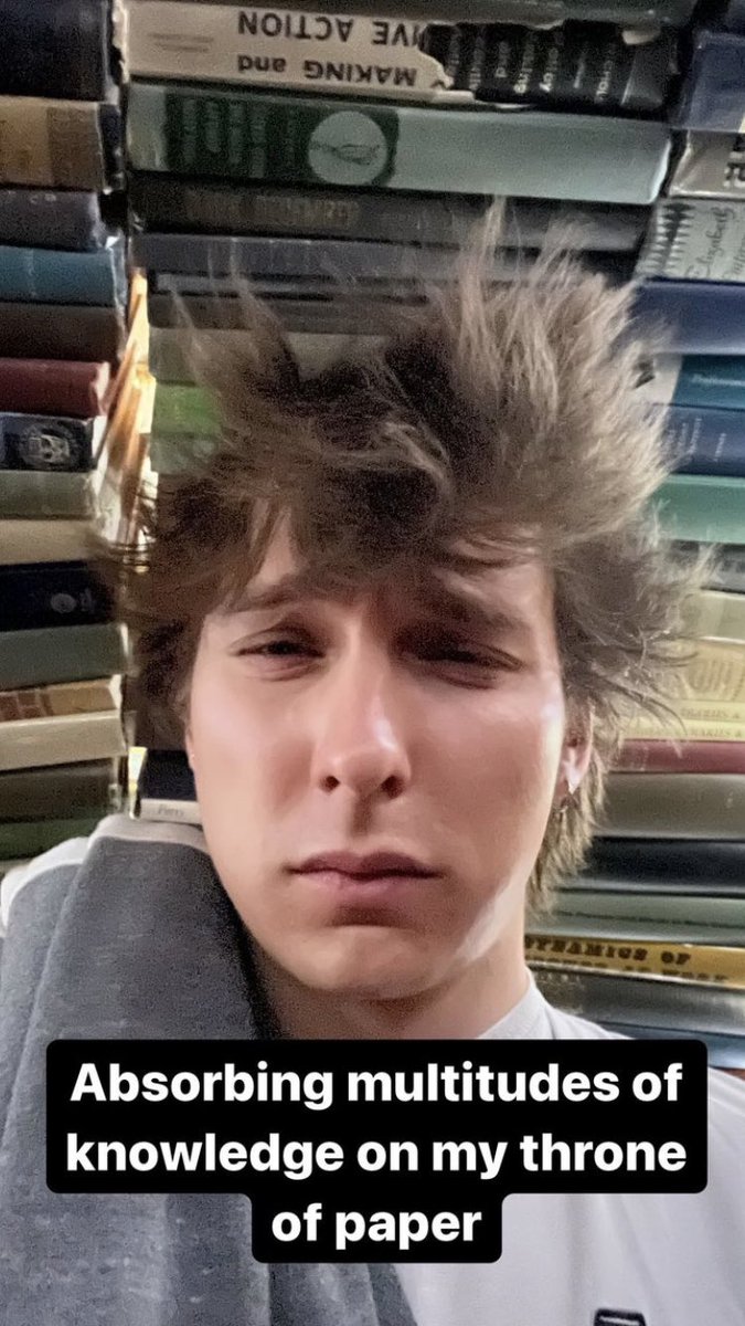 jumperrdog's tweet photo. i am so confused by the perspective in the image. is he looking down? are the books above him? he’s literally in the book dimension rn bro https://t.co/htFToAEdzE