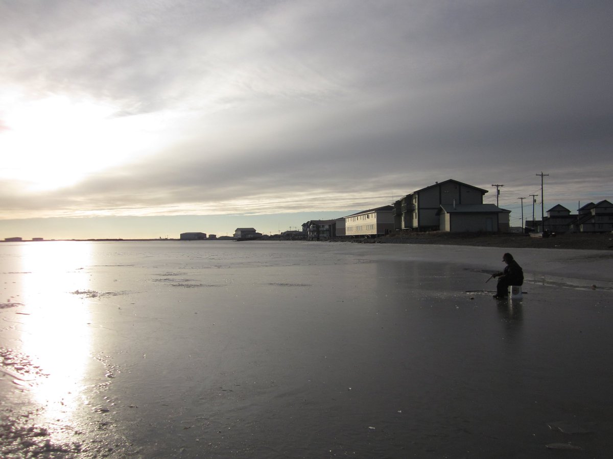 A man ice fishing for tomcod in Kotzebue, Alaska (2014)