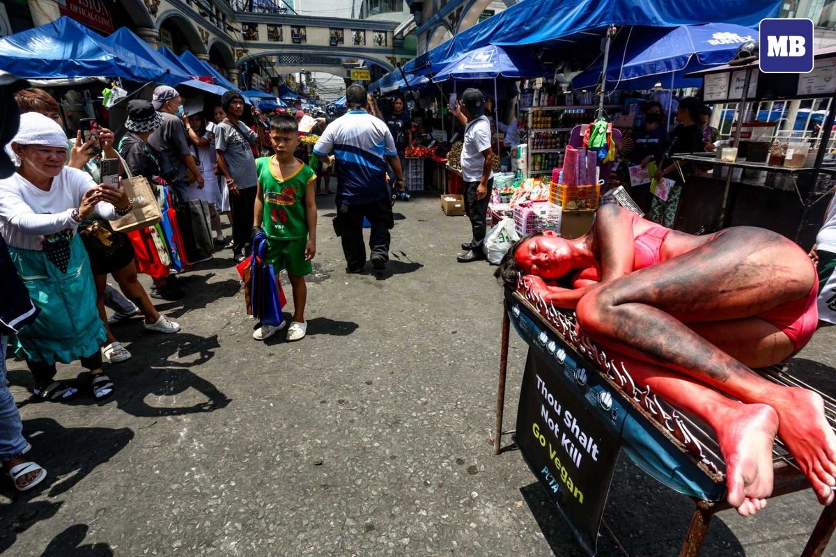 LOOK: A member of animal rights organization PETA staged a protest by portraying a 'human barbeque' outside the Plaza Miranda in Manila on Tuesday, March 26, calling on the public against animal abuse and to refrain from eating animals such as chickens, pigs, and cows, not just