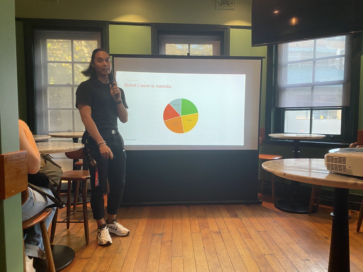 Our first speaker of the night is the one and only
<a href="/mqcastaneda/">Miguel Castañeda</a>, speaking about the role of the microbiome in colorectal cancer!! Who knew that chocolate could be used as such a good an analogy for alpha and beta diversity 🤔 (yum?) #JAMS #JAMSSyd #microbiology