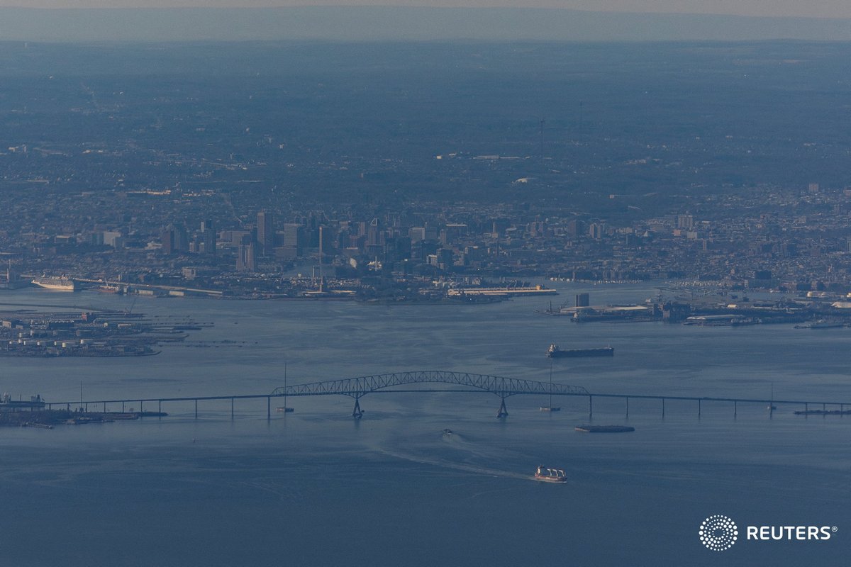 From Sunday: A ship moves under the Francis Scott Key Bridge near Baltimore, on the day U.S. President Joe Biden travels to Washington. Photo by @tombrennerphoto