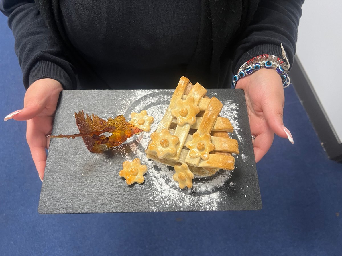 Scrumptious apple pie served with homemade custard and caramelised sugar shards. This is one of two final graded dishes produced for a student's BTEC hospitality and catering coursework. Our mouths are watering! The presentation is outstanding, and this looks so delicious!