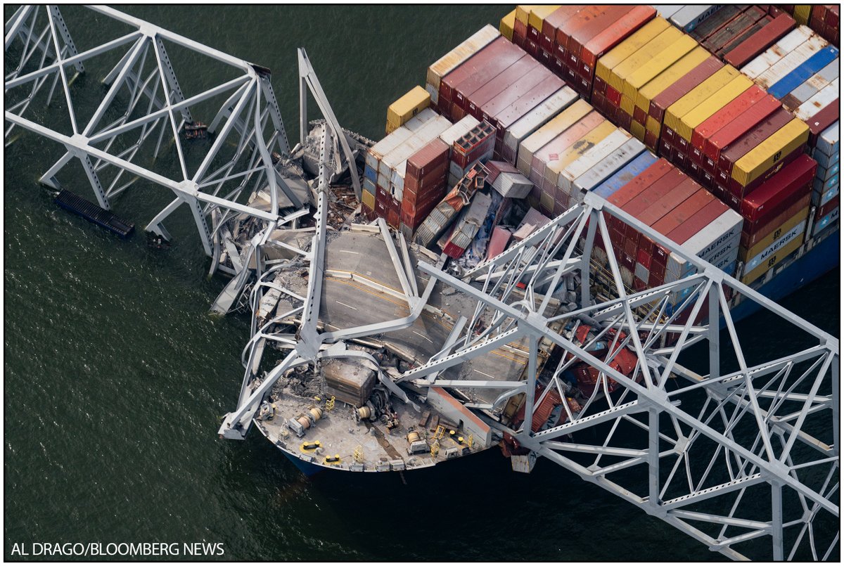 An aerial view shows the crumbled road on top of the Dali container vessel after striking the Francis Scott Key Bridge that collapsed into the Patapsco River in Baltimore, Maryland on Tuesday.