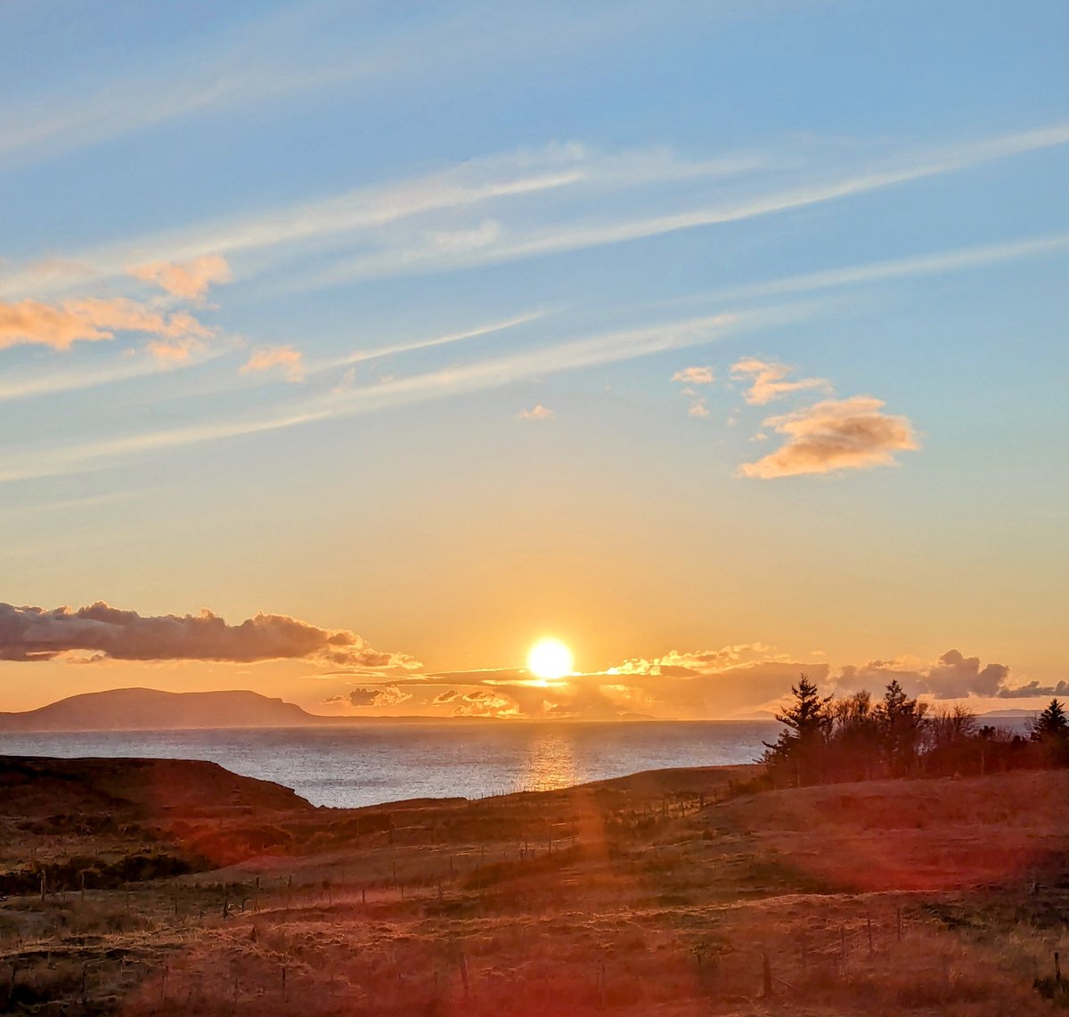 There's heat in the colours of today's sunset but oh my goodness, the wind chill is vicious! View across the croft and over the sea to Skye