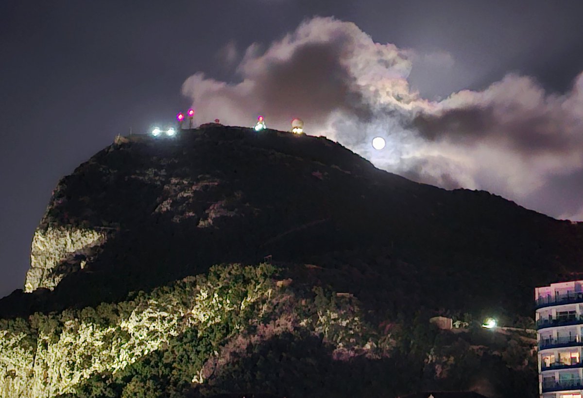 The final full moon of winter or worm moon rising above the rock. It owes its name to Native Americans who noted winter’s end by the trails of earthworms it illuminated on the newly thawed soil.