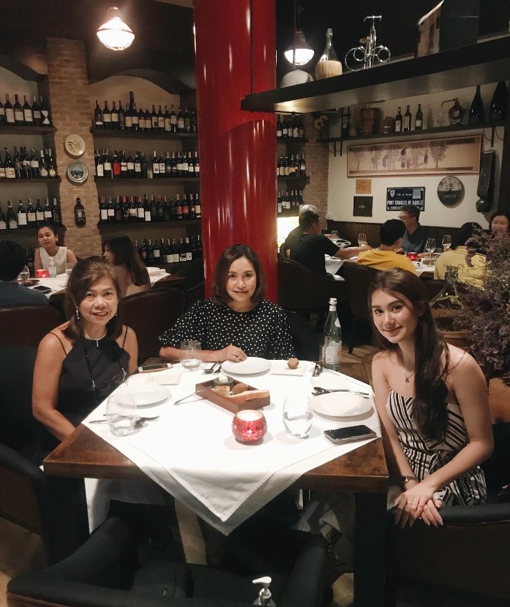 Web676's tweet image. "In the soft glow of evening, she patiently awaits dinner, her anticipation mirrored in the twinkling lights around her. Dressed in understated elegance, she embodies the allure of the night, grace and timeless beauty. #ElegantEvening #AwaitingDinner #NighttimeCharm"