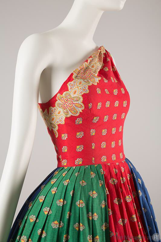 Continuing the weekly focus on women designers. Carolyn Schnurer (American, 1908-1998), travelled the world to gain inspiration for her designs. Black & white printed cotton dress, 1955 @RISDMuseum. Dress in red, green & blue cotton, 1954 @museumatFIT #1950s #dresshistory