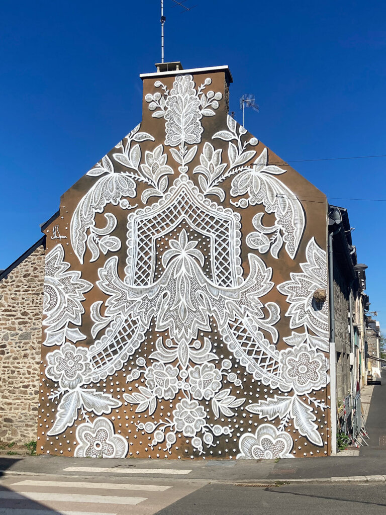 Polish artist NeSpoon from Warsaw, known for her street art featuring traditional lace pattern imagery #womensart