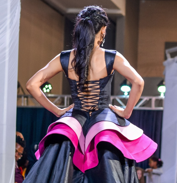 Runway Details: The corset-inspired bodice with its intricate lace-up detailing is a nod to the iconic corsetry that emerged in 16th century Europe and became a symbol of status and beauty standards for centuries after. #corset #Fashionhistory #runway #FashionWeek