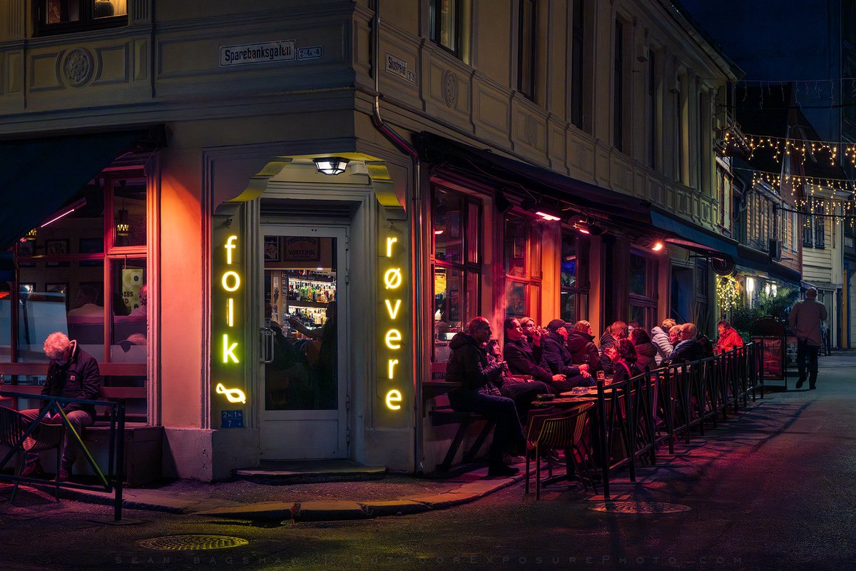A night street scene I liked in Bergen, Norway. The red glow is from heaters so people can sit outside even in the Norwegian winter.