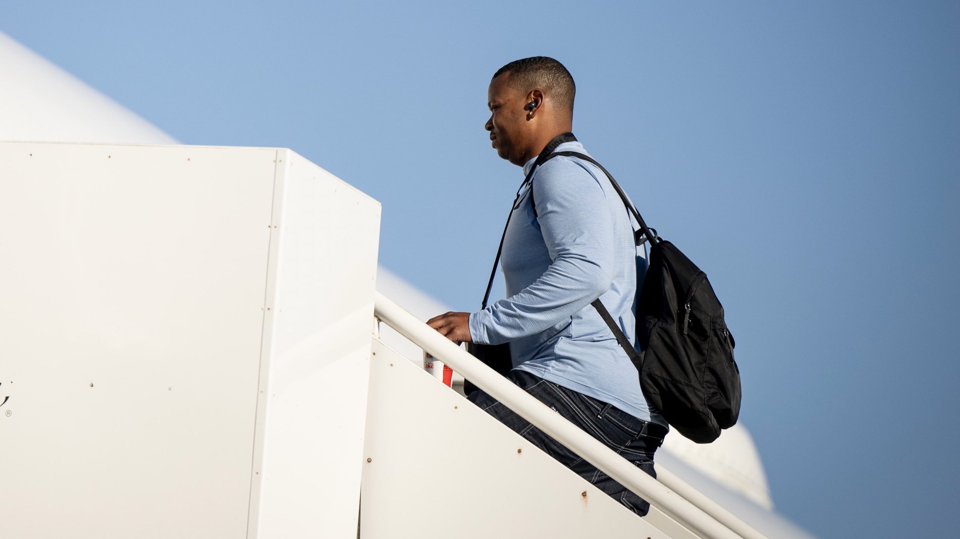 Rafael Devers walks up the stairs as he boards a flight from Texas to Seattle.