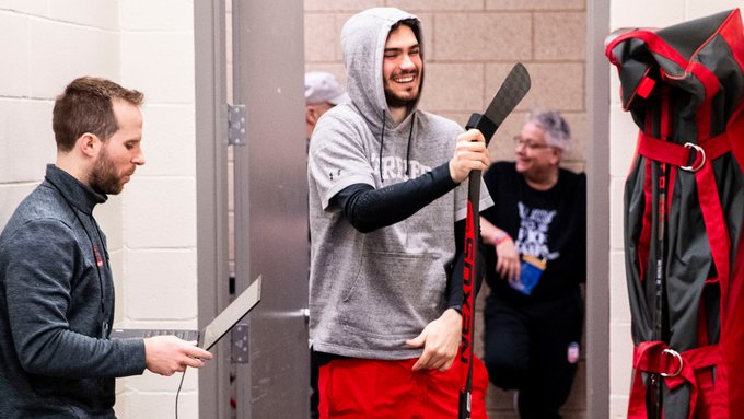 Sam Stevens smiling while taping a stick