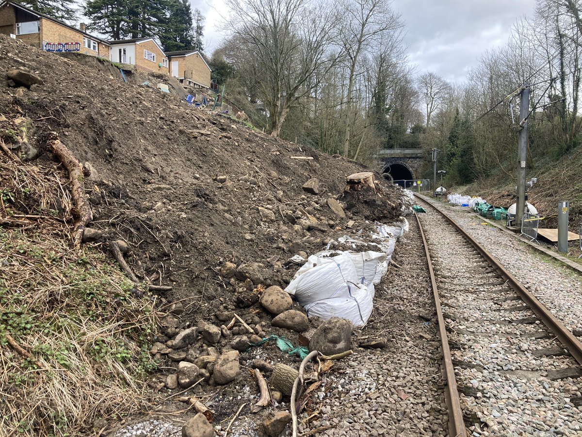 Network Rail will demolish two homes above Baildon landslip because of fears they could collapse. Railway between Bradford and Ilkley not expected to reopen until late June. @BBCLookNorth