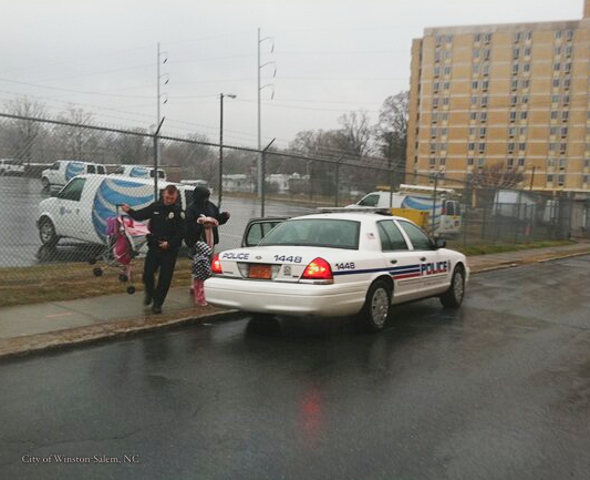 EpochInspired's tweet photo. "A small act of kindness can go a long way, and here’s a story where getting in a car means an awful lot.

As a dark, cold, and wet day settled on Winston-Salem, a woman pushed her young child in a stroller. Police Officer Charlie Ziegler noticed that. So he went into “safety” mode. He went up to the woman and told her to get into his car. Then he took her and her child a little further down the road to a daycare center.

A photo of the officer doing this was posted on Facebook and went viral. But he did not think what he did was any big deal.

Says the officer: “You see someone and you just help them.”

Officer Ziegler himself is the father of two young children and claims he would have helped the woman even if he had been off-duty. His mother-in-law, Donna Johnson, said that’s just the way he is, saying: “He’s just that type of person. Very helpful and outgoing, and he doesn’t want to see anyone in trouble or in need.”

And his wife, Rachel, was actually taken aback at how much attention her husband was receiving for such a deed. Says Rachel: “Last Tuesday I was actually having lunch with him and he told me that someone from the local news had contacted him and it surprised me. You would just expect Anyone to do that…to save someone from the freezing rain.”

Credit: City of Winston-Salem, NC -twitter.com/CityofWS