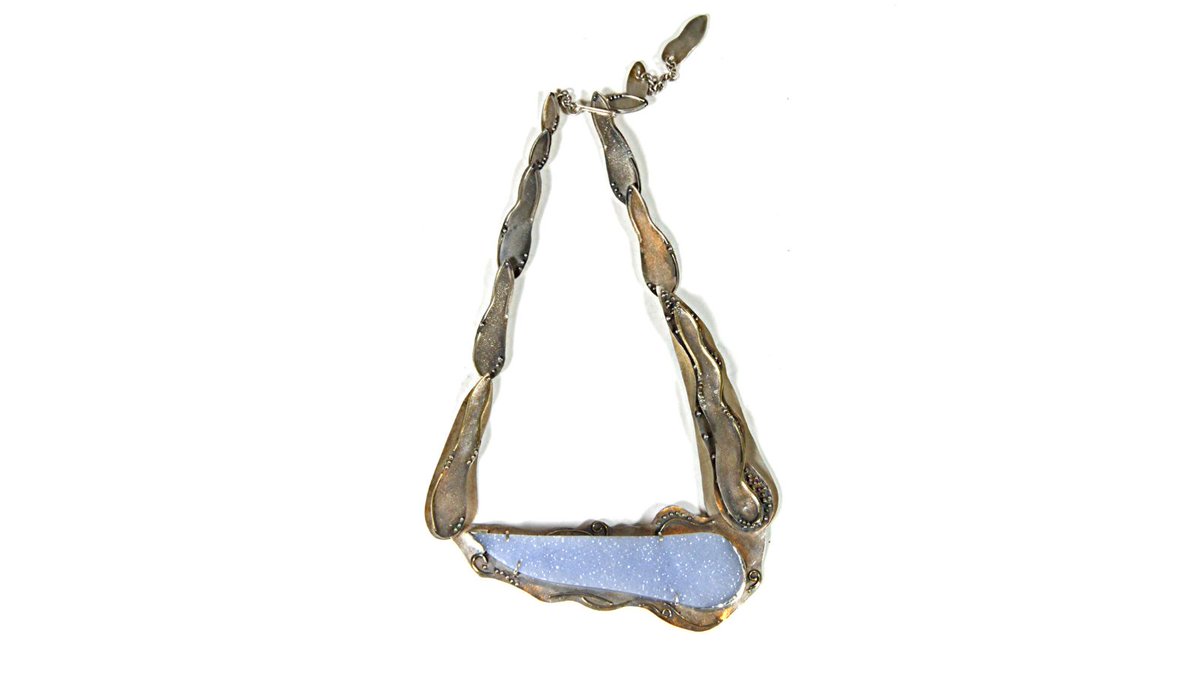 Michele White's Blue Lace Agate Necklace has been skilfully crafted out of silver and 18ct gold, and is set with drusy blue lace agate. This handmade piece features a unique asymmetric design, with the agate sitting on an angle when worn. #agate #asymmetricnecklace #handmade
