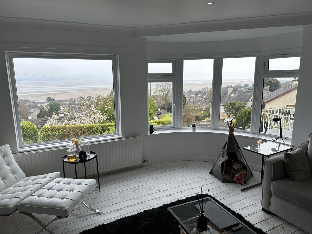 Even on a cloudy day, the view from the living room across Morecambe Bay is spectacular and ever-changing! 🇬🇧 The teepee is a little dog bed, in case you were wondering! Book here: linktr.ee/craggview #grangeoversands #morecambebay #interiordesign #perfectview #airbnb #vrbo