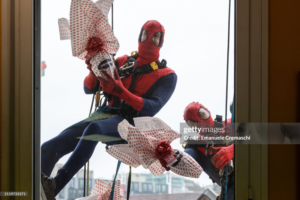 Rope access workers wearing comic-based superhero #Spiderman costumes donate #eastereggs to hospitalized children at Clinica Pediatrica De Marchi in Milan, Italy. I March 28, 2024 | 📷:  Emanuele Cremaschi #GettyNews #easter