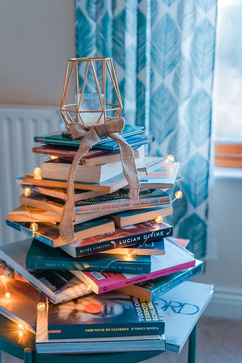 What does your favorite book stack look like? I love the fairy lights on this one! #bookstack #bookmail #bookish #bookstagram #books #amreading #booknerd #bookworm
