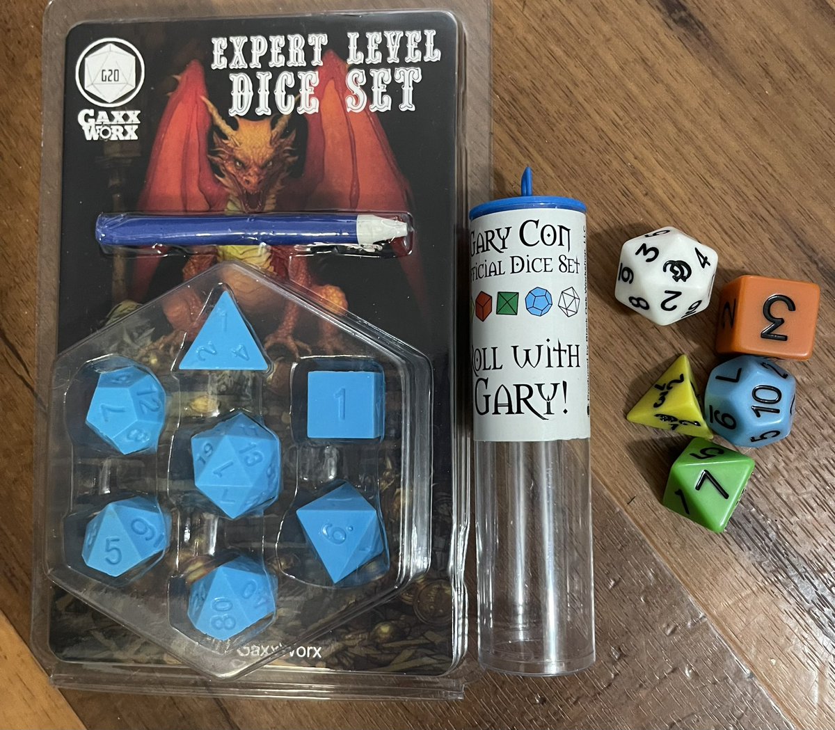 Some great swag I got @GaryCon ! A set of the Expert Level dice that look like they came out of the box set, complete with a white crayon! And the retro OD&D Roll With Gary Dice! ❤️